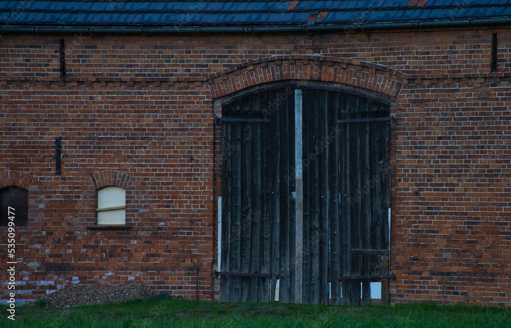 old black wooden doors of brick barn old black wooden doors of brick barn