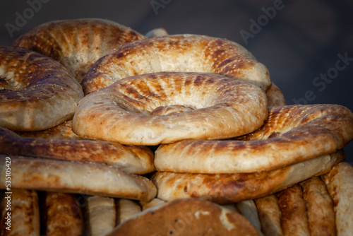 Uzbek flatbread from a tandoor. Traditional bread in Central Asia. Bread flatbread with sesame seeds