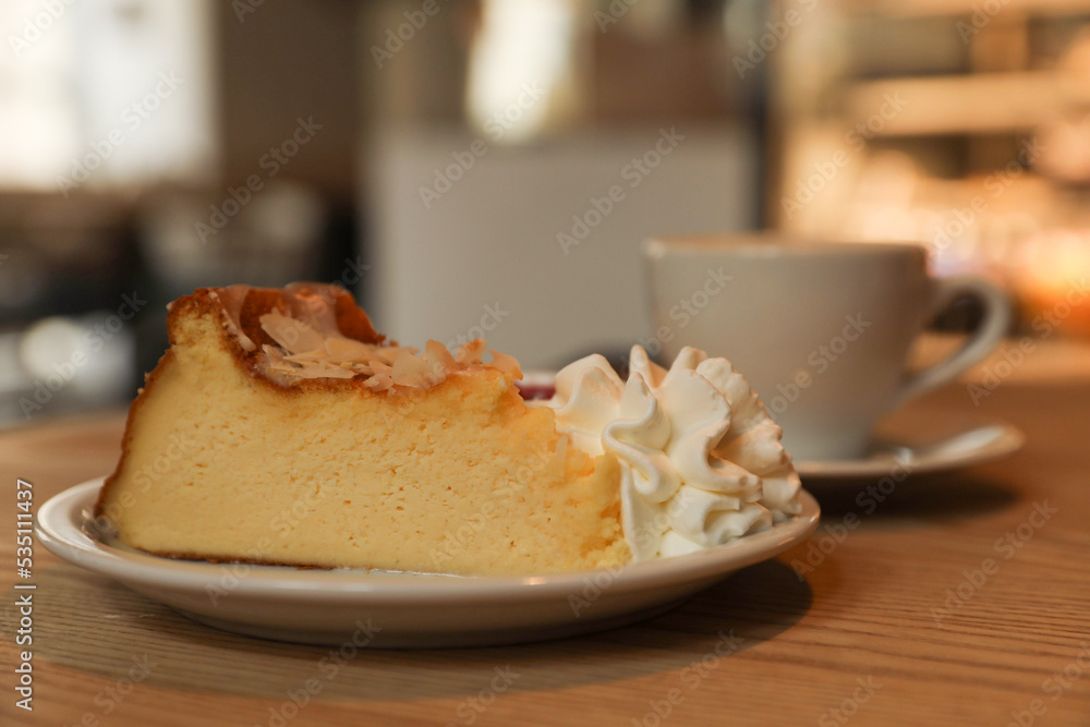 Cup of aromatic coffee and delicious dessert on wooden table in cafe, closeup Cup of aromatic coffee and delicious dessert on wooden table in cafe, closeup