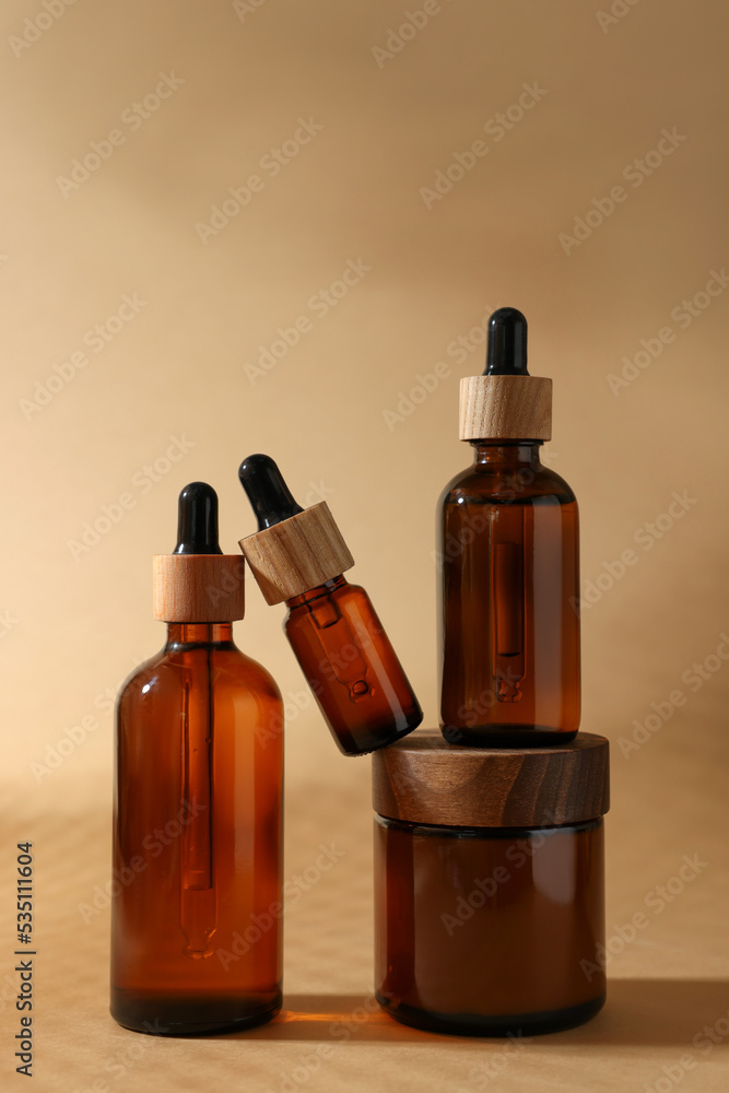 Set with different luxury cosmetic products on dark beige background Set with different luxury cosmetic products on dark beige background