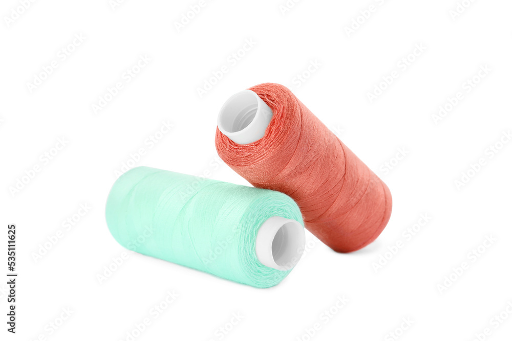 Different colorful sewing threads on white background Different colorful sewing threads on white background