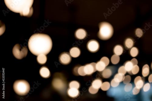 Fototapeta Naklejka Na Ścianę i Meble -  abstract blurred background of lights. Abstract blurry dark indoor plaza hall with a lot of small bokeh