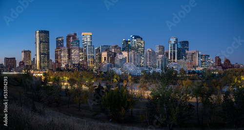 Calgary's beautiful skyline on early morning in the heart of autumn with fall colours on the trees.