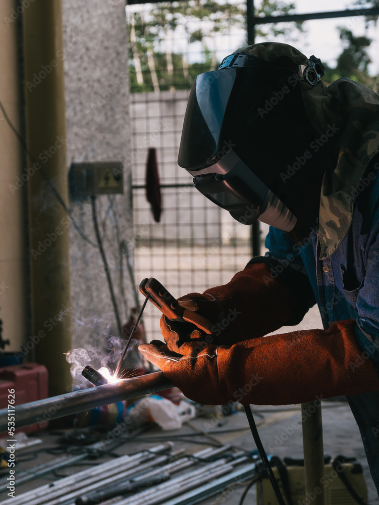 Iron soldering, Man working on iron soldering, welding sparks Iron soldering, Man working on iron soldering, welding sparks