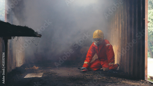 Firefighter Rescue training in fire fighting extinguisher. Firefighter fighting with flame using fire hose chemical water foam spray engine. Fireman wear hard hat, safety suit uniform for protection