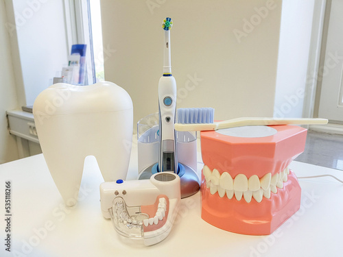 dentist office. orthodontic model and dentist tool - demonstration teeth model of varities of orthodontic bracket or brace,Electric toothbrush photo