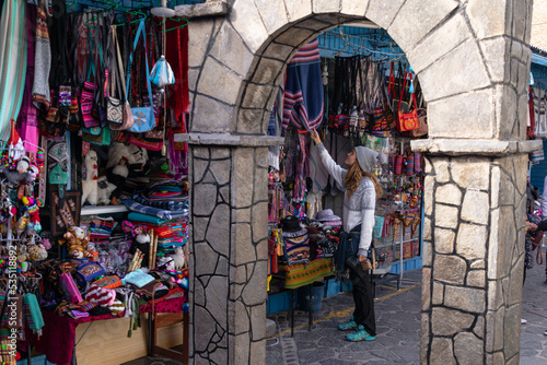 Tourist woman traveling and looking at souvenirs in an outdoor craft market in Peru.  Tourism and vacations in Peru.  Colca Valley, Chivay. photo
