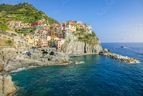 Manarola bay above cliffs, Cinque Terre, Liguria, Italy with boats
