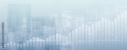 Double exposure of financial chart with stock market line graph and stack of coins in cityscape background