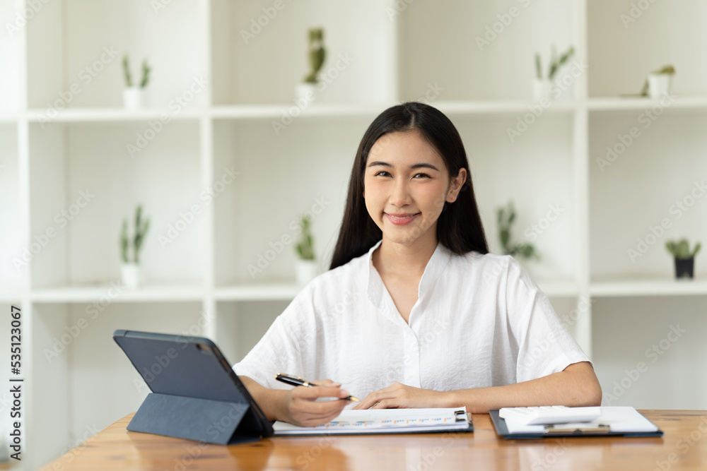 Asian woman working with laptop in her office. business financial concept. Asian woman working with laptop in her office. business financial concept.