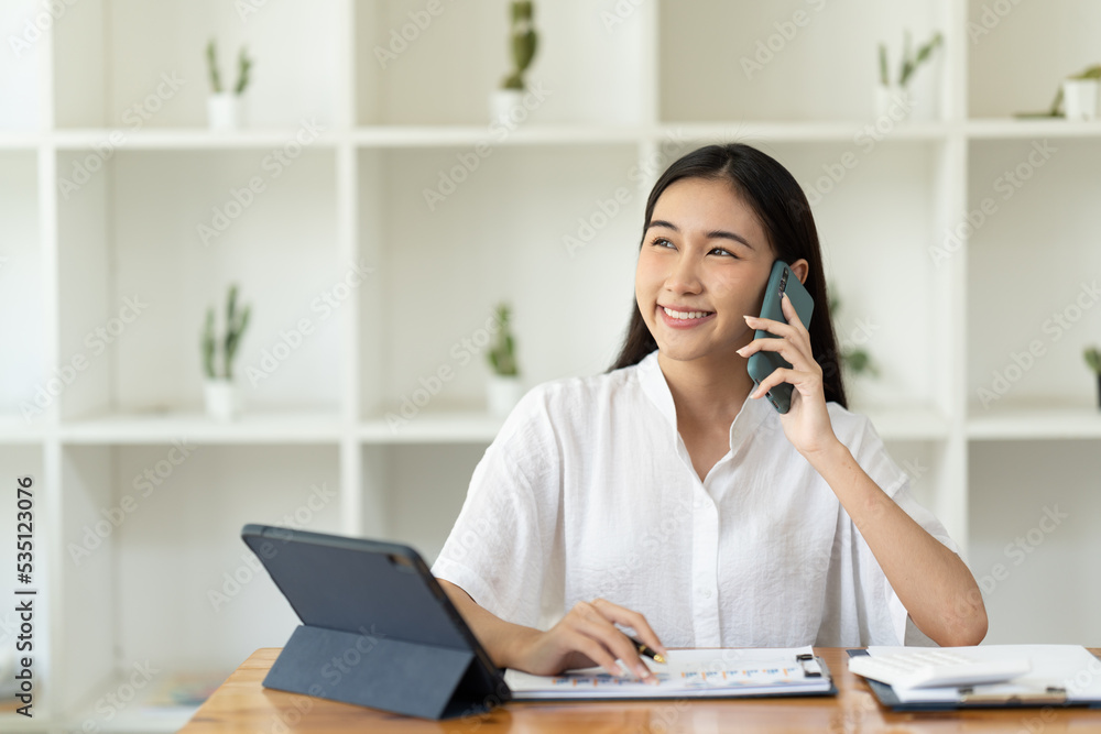 Asian businesswoman in formal suit in office happy and cheerful during using smartphone and working. Asian businesswoman in formal suit in office happy and cheerful during using smartphone and working.