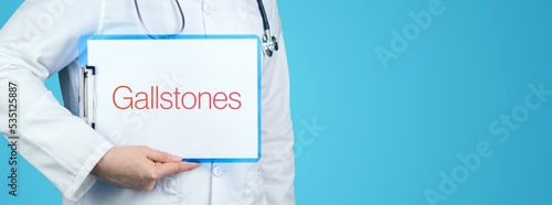 Gallstones. Doctor with stethoscope holds blue clipboard. Text is written on document. photo
