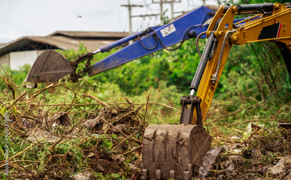 Backhoe digging soil at construction site. Bucket of backhoe digging
