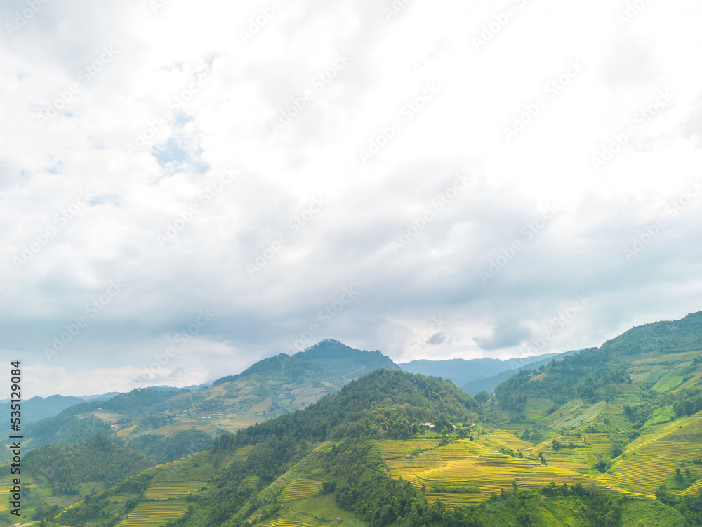 Naklejka premium Aerial view of golden rice terraces at Mu cang chai town near Sapa city, north of Vietnam. Beautiful terraced rice field in harvest season in Yen Bai, Vietnam