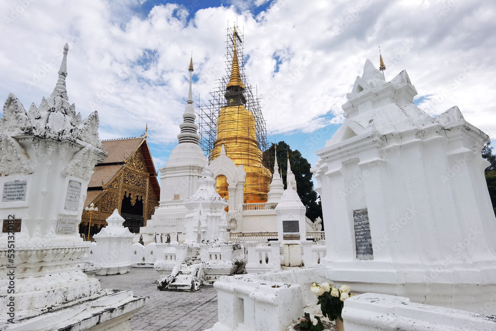Fototapeta premium The beautiful pagoda with blue sky and clouds at Wat Suan Dok, Chiangmai, Thailand. 
