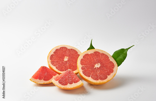 Grapefruit halves and quarters on a white background. Vitamin C.