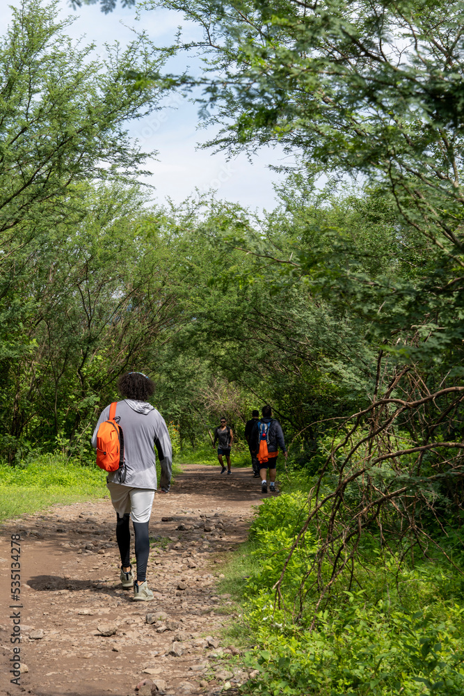 two young men and friends descending in the ravine, vegetation and trees, huentitan ravine guadalajara, mexico two young men and friends descending in the ravine, vegetation and trees, huentitan ravine guadalajara, mexico