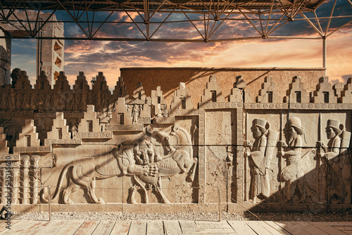 Beautiful sunset light over the magnificent sculptures of Ancient Persepolis in Iran photo