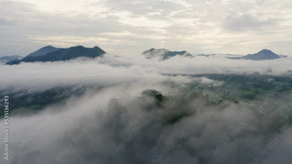 Phu Tok Mountain in Chiang Khan, Loei Thailand, Drone flying above the Telecommunication Tower station on mountain and fog sea. Aerial view of mountain peak over misty cloud. Footage b roll 4k. Phu Tok Mountain in Chiang Khan, Loei Thailand, Drone flying above the Telecommunication Tower station on mountain and fog sea. Aerial view of mountain peak over misty cloud. Footage b roll 4k.