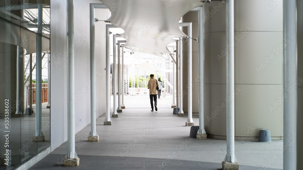 A man walks through an aesthetic hallway. The man walks through the corridors. A man walks through an aesthetic hallway. The man walks through the corridors.