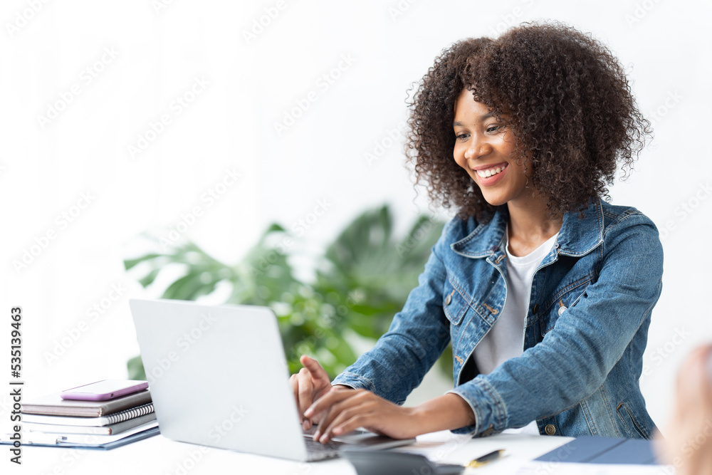 Close up portrait of a young american african woman looking at laptop. Close up portrait of a young american african woman looking at laptop.