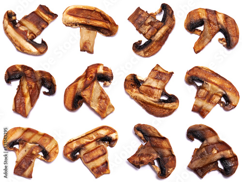 Grilled Slices of champignon mushrooms with stripes from a grill isolated on white background
