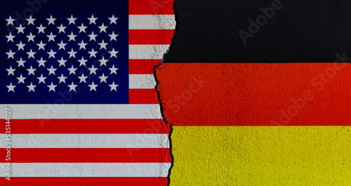 American and German flags on broken cracked wall