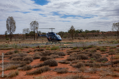 Canvas-taulu Passengers getting ready for a helicopter ride on a cloudy day at Ayers Rock Uluru-Kata Tjuta in Northern Territory, Australia