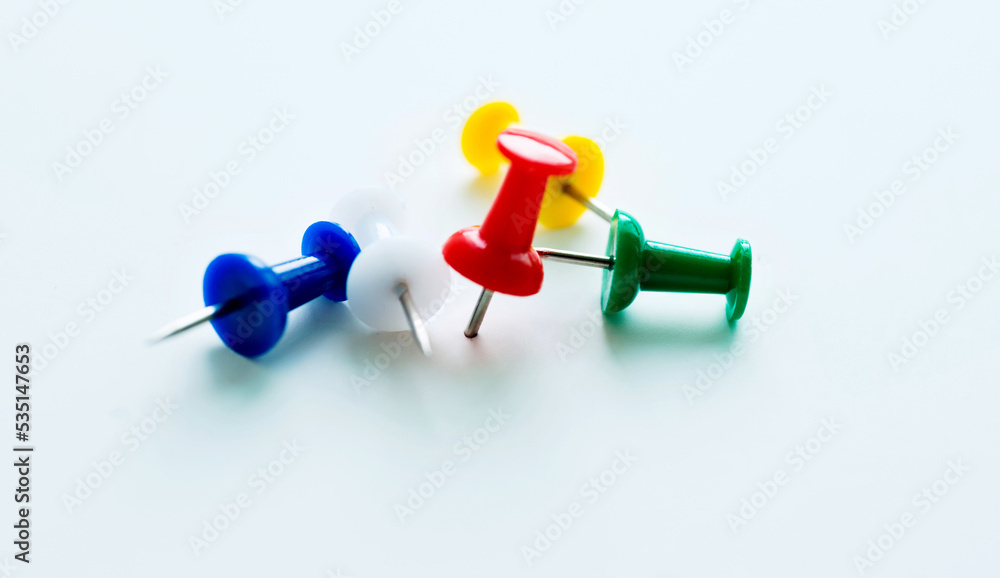 Many colored thumbtacks on white background Many colored thumbtacks on white background