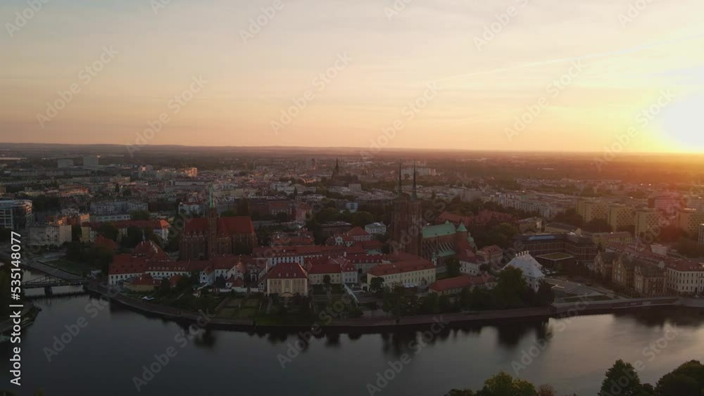 Drone flight over Tumski island and Cathedral of St John the Baptist in Wroclaw at morning sunrise light, Aerial view of old town with historical architecture in Wroclaw city, Poland Drone flight over Tumski island and Cathedral of St John the Baptist in Wroclaw at morning sunrise light, Aerial view of old town with historical architecture in Wroclaw city, Poland
