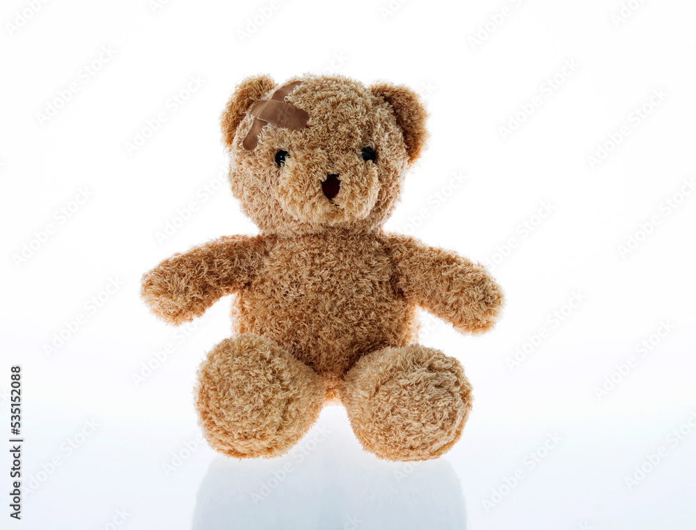 Fototapeta premium Teddy bear with bandages isolated on white background