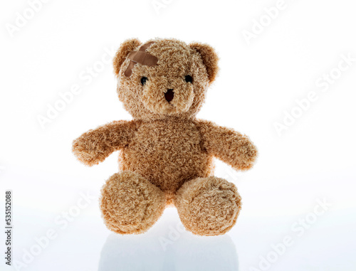 Teddy bear with bandages isolated on white background