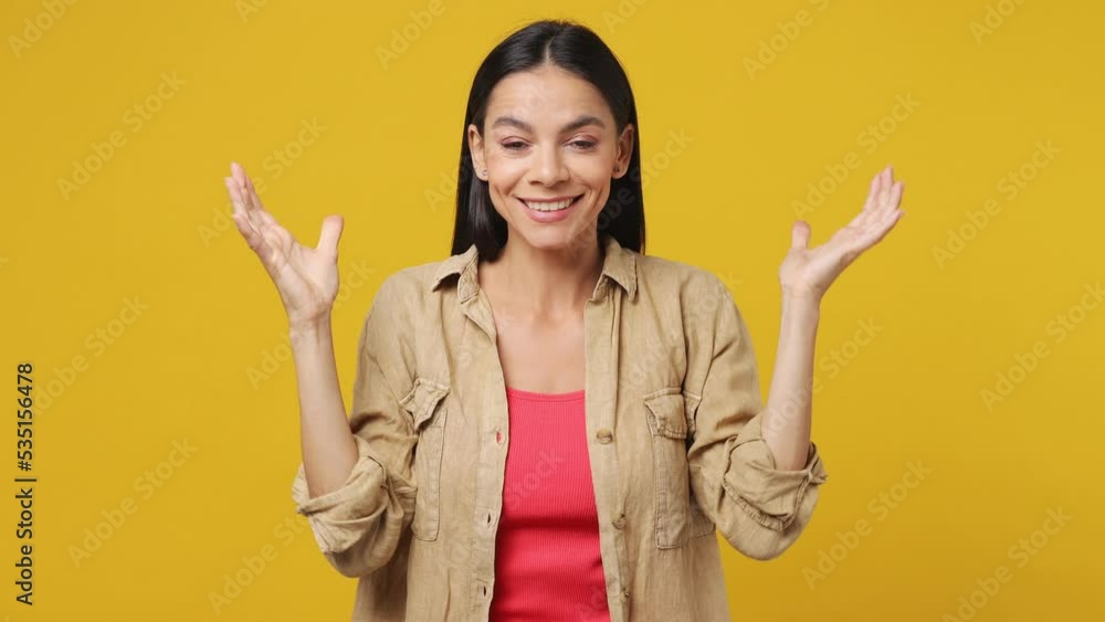 Young latin woman 30s she wear beige shirt pink t-shirt looking shocked surprised wow showing hands brain explosion head isolated on plain yellow background studio portrait. People lifestyle concept Young latin woman 30s she wear beige shirt pink t-shirt looking shocked surprised wow showing hands brain explosion head isolated on plain yellow background studio portrait. People lifestyle concept