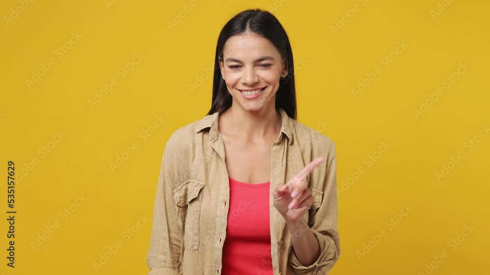 Young latin woman 30s wear beige shirt pink t-shirt look camera pointing fingers herself ask say who me no thanks i do not need it isolated on plain yellow background studio. People lifestyle concept Young latin woman 30s wear beige shirt pink t-shirt look camera pointing fingers herself ask say who me no thanks i do not need it isolated on plain yellow background studio. People lifestyle concept