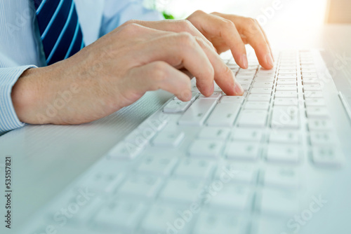 Male office worker typing on the keyboard