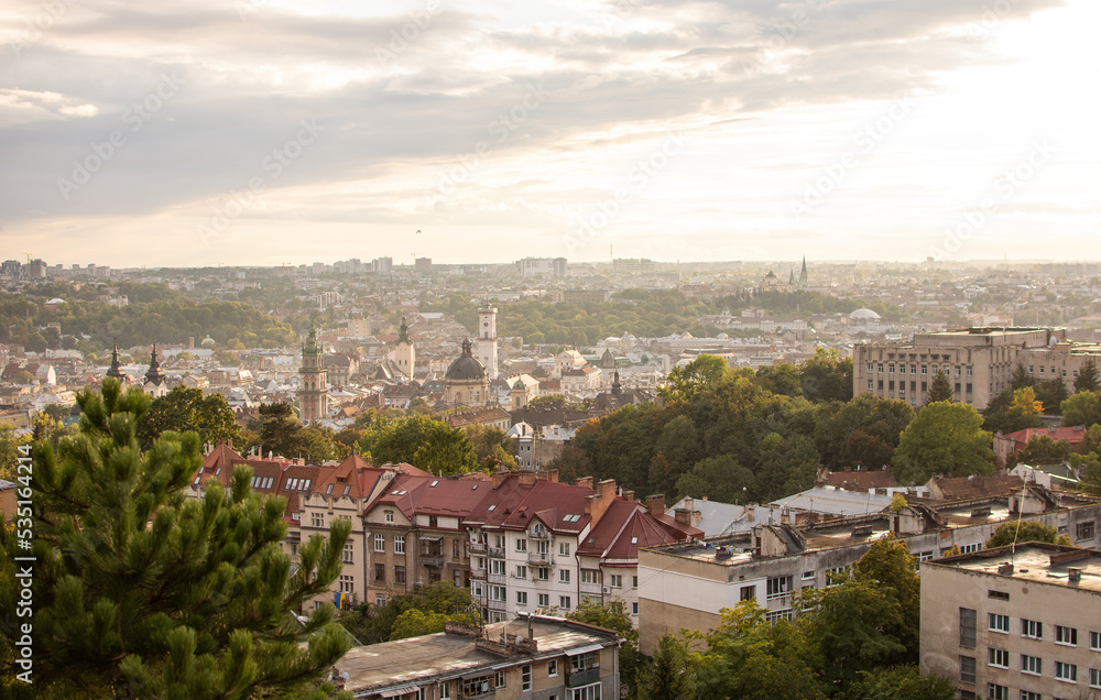 Top view of the roof of an old European city - Lviv. Old architecture, old metal rusted roofs at sunset.