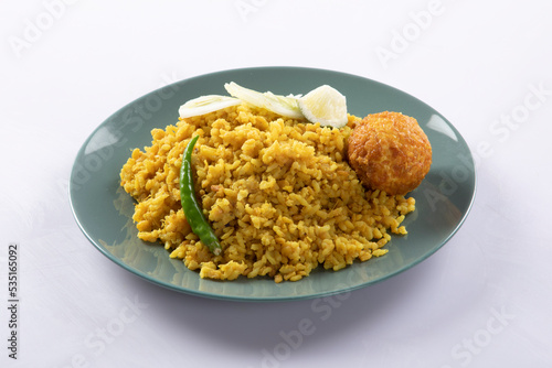 Bengali dish khichdi or khichuri made from a combination of lentils and rice along with Indian spices. in a mud bowl isolated on white background Bengali dish khichdi or khichuri.