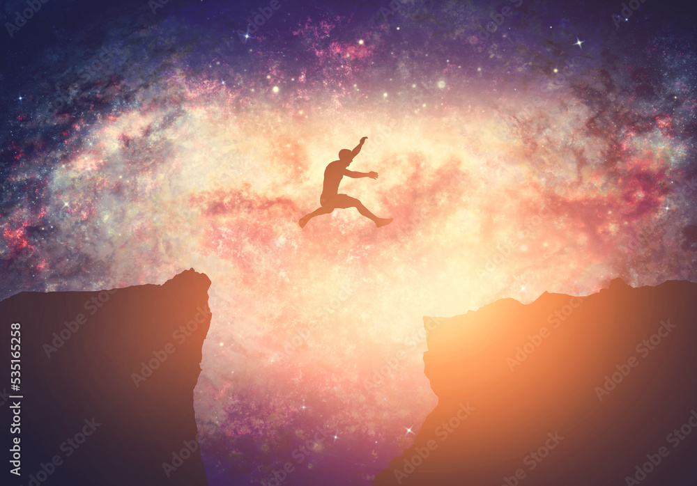 Making a dream come true. Man jumping between mountains on galaxy night sky - obrazy, fototapety, plakaty 