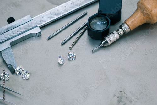 Working desk for craft jewelery making with professional tools. Wedding rings making. Top view copyspace on matel background photo