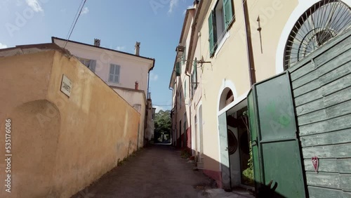 SLOWMOTION: Historic and colorful italian street in old town of Molini Liguria in summer with blue sky. Camera is moving forward. photo