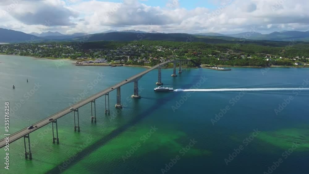 Aerial View of Boat Sailing Under Gisundbrua and Traffic on Bridge Connecting Lofoten Islands With Mainland Norway at Sunny Summer Day, Drone Shot Aerial View of Boat Sailing Under Gisundbrua and Traffic on Bridge Connecting Lofoten Islands With Mainland Norway at Sunny Summer Day, Drone Shot