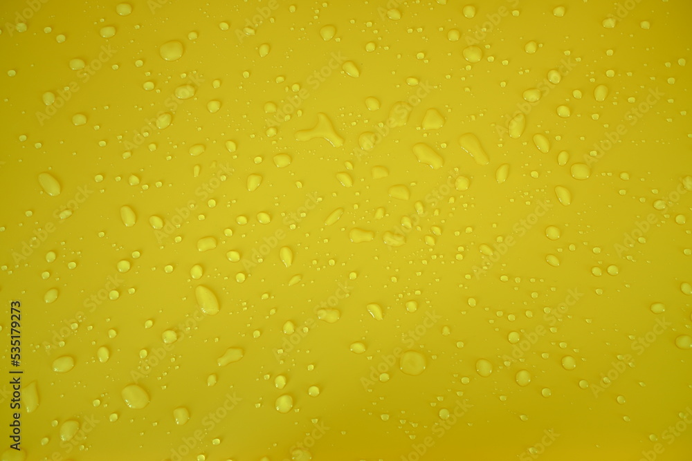 Defocus blurred water drops on orange background. waterdrops detail the background. Water splash, water spray background. Calm orange background with water drop. Defocus blurred water drops on orange background. waterdrops detail the background. Water splash, water spray background. Calm orange background with water drop.