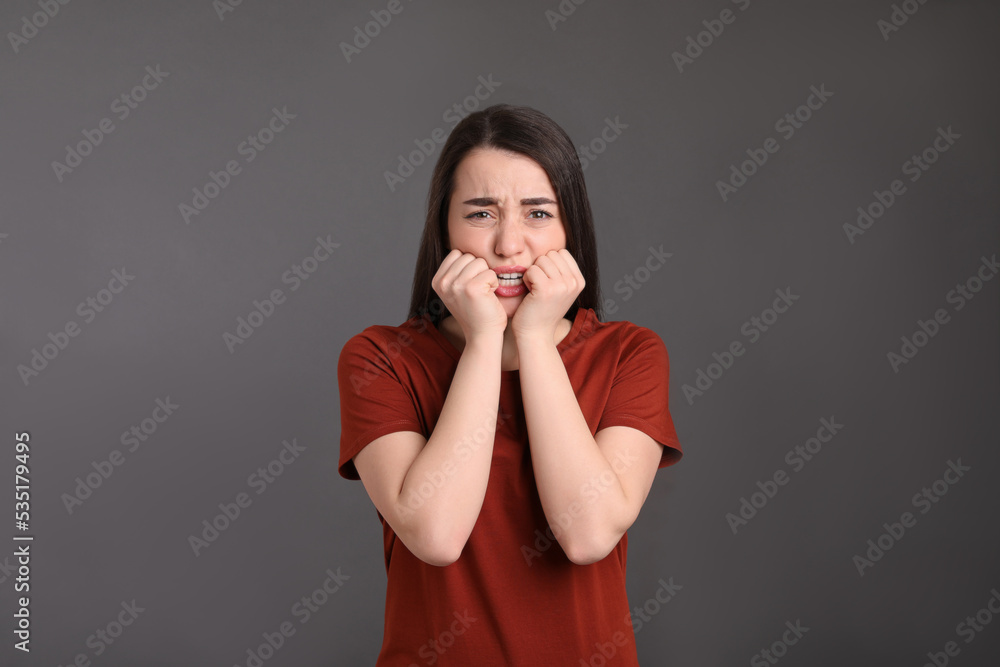 Portrait of emotional young woman on dark grey background. Personality concept Portrait of emotional young woman on dark grey background. Personality concept