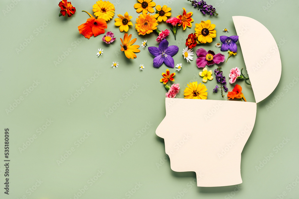 World mental health day concept. Paper human head symbol and flowers on blue background - obrazy, fototapety, plakaty 