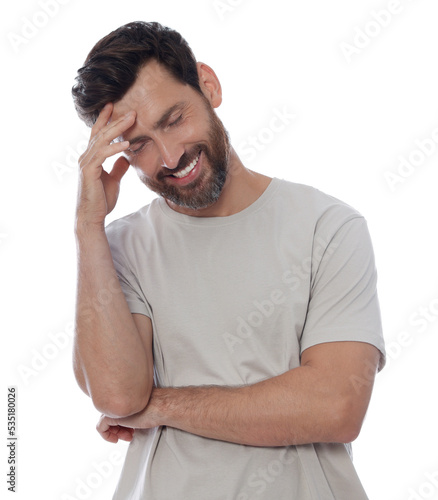 Embarrassed man covering face with hand on white background