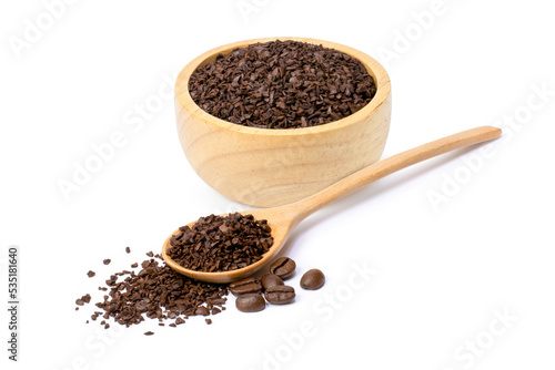 Instant granules coffee with roasted coffe bean in wooden bowl and spoon isolated on white background. 