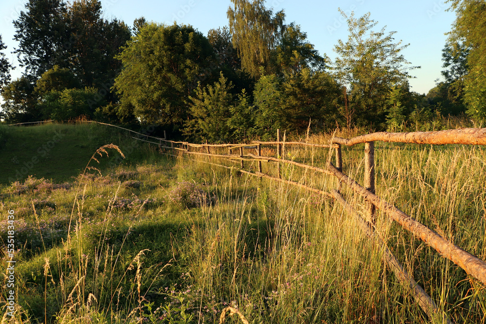 Picturesque view of countryside with wooden fence in morning Picturesque view of countryside with wooden fence in morning