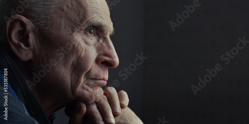 Side view of sad widowed senior man with pensive look. Mental health and grandparents care.
