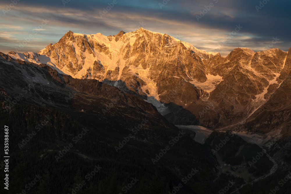 Mountain with glacier at sunrise. Monte Rosa in the European alps, Macugnaga, Italy. Spectacular rock and ice wall