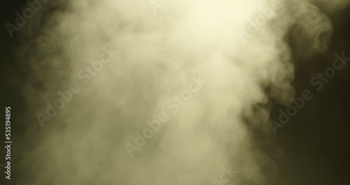 Abstraction, white smoke, steam, rises up on a dark background. Close-up.